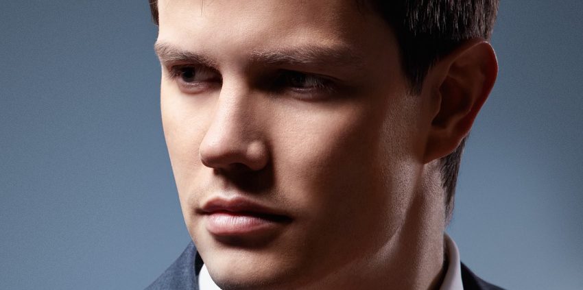A man in a suit and tie looking at the camera.