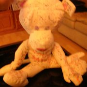 A stuffed animal sitting on top of a wooden floor.